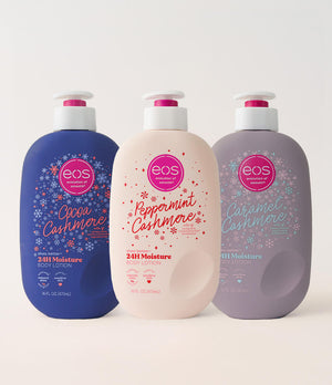 Three EOS Cashmere lotion bottles in blue, pink, and purple on a white background