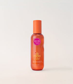 A bottle of EOS Pumpkin Chat room spray body mist with an orange cap and orange translucent bottle, set against a clean off-white background.