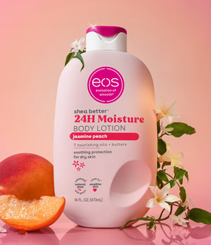 EOS jasmine peach body lotion bottle with peach and flowers on a pink background