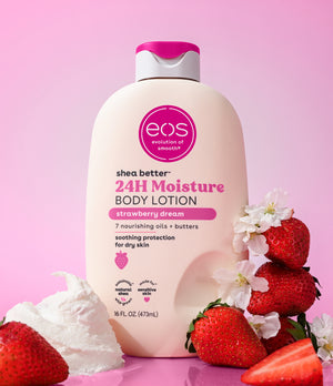EOS strawberry dream body lotion with strawberries and flowers on a pink background