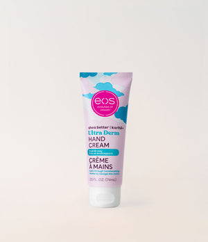 A squeeze tube of EOS Ultra Derm Hand Cream standing upright against a clean, light beige background. The packaging features a pastel lavender body with blue cloud graphics, a pink circular 'eos' logo, and teal and black text.