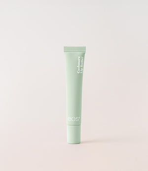 Green tube of eos lip balm on a light gray background