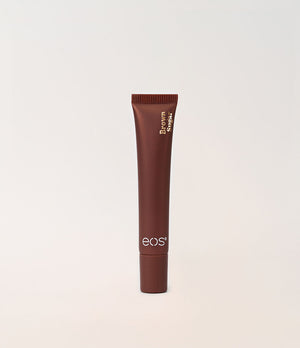 A single tube of eos lip shine on a clean, light off-white background.