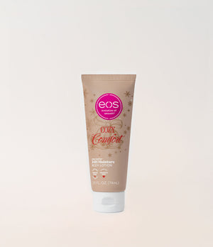 A squeeze tube of EOS 'Cozy Comfort' hand cream lotion, featuring a warm beige background with a pink circular EOS logo and gold decorative accents, set against a clean off-white background.