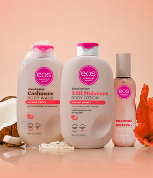 Three eos products on a peach background with coconut and flower elements.
