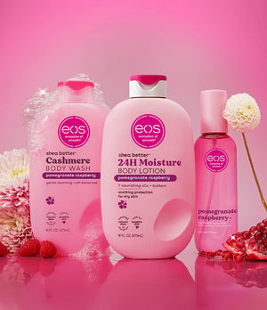 Three EOS products on a pink background with flowers and pomegranate pieces.