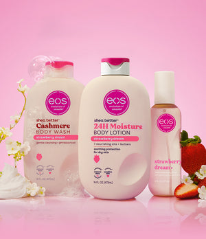 eos strawberry dream body wash, lotion, and body lotion on a pink background with strawberries and flowers.