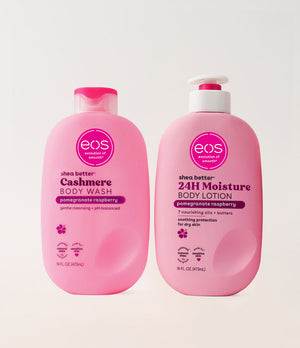 Two pink bottles of eos shea butter body wash and lotion on a white background