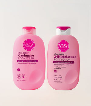 Two pink bottles of eos shea butter body wash and lotion on a white background