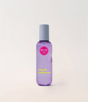 Purple bottle of EOS Vanilla Cashmere body mist on a light gray background