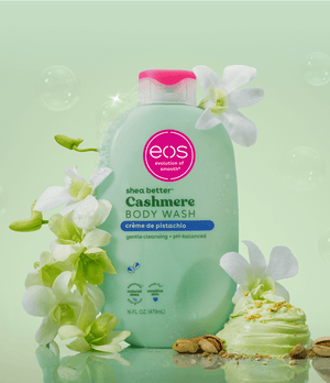EOS Cashmere Body Wash bottle with flowers on a light green background