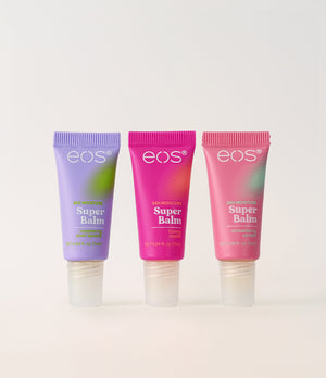 Three tubes of eos mini Super Balm on a beige background