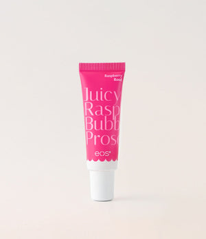 Pink tube of eos lip balm on a light gray background