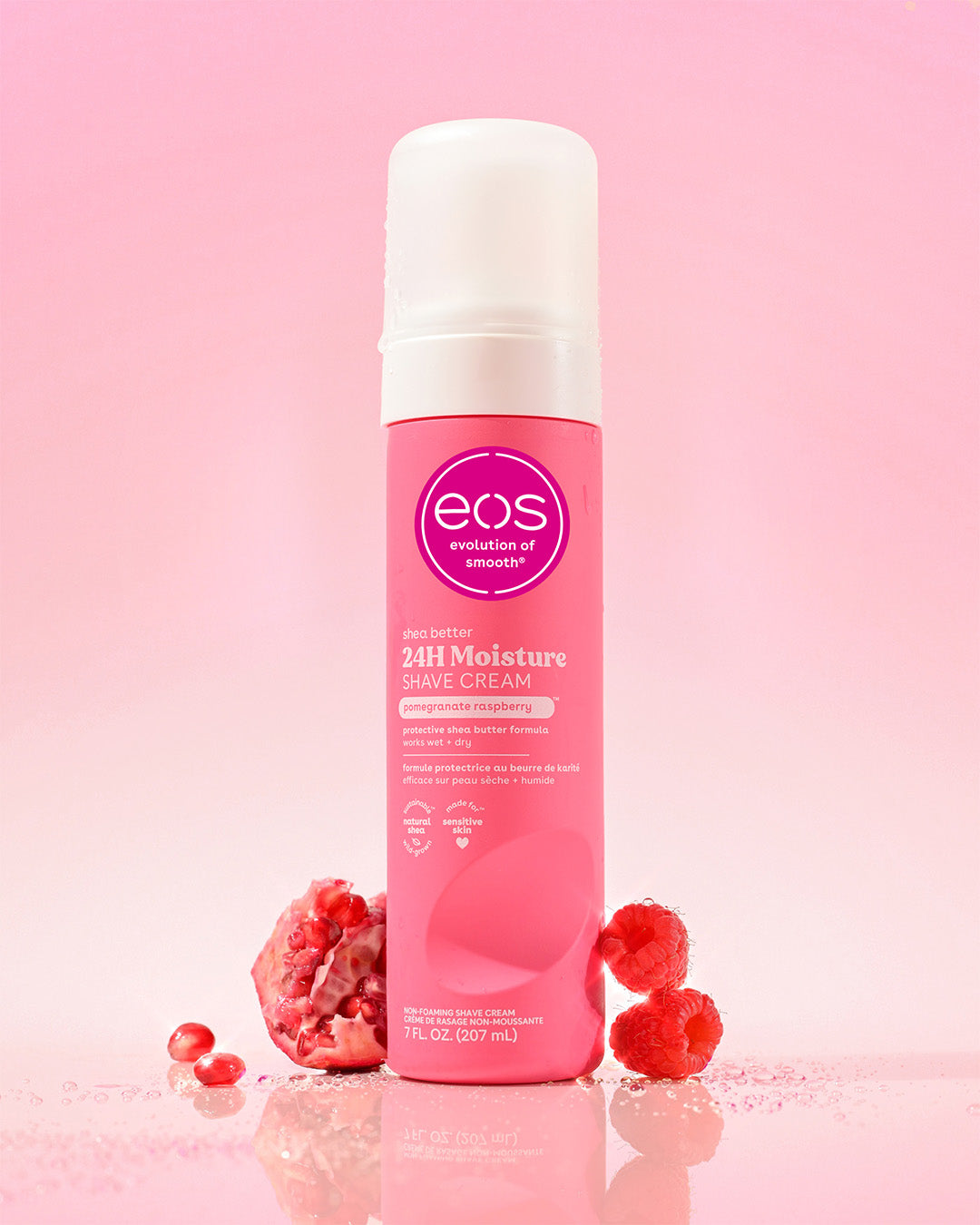 Pink bottle of eos raspberry pomegranate shave cream with raspberries on a pink background