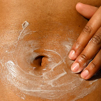 rubbing lotion on stomach